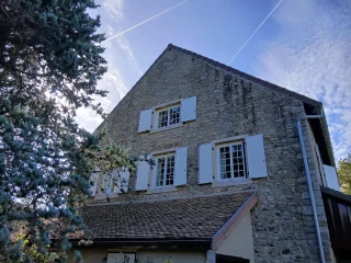 Volets battants aluminium sur une façade en pierre à Barizey